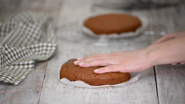 Female Hands Cutting a Carrot Cake on Layers