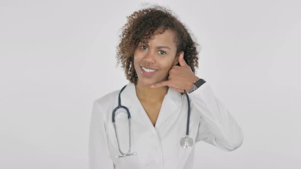 Call Me Gesture By African Female Doctor on White Background alt
