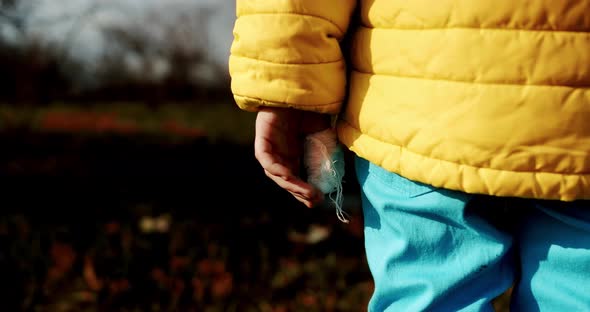 Child Dressed in the Colors of the Ukrainian Flag with the Bandaged Finger alt