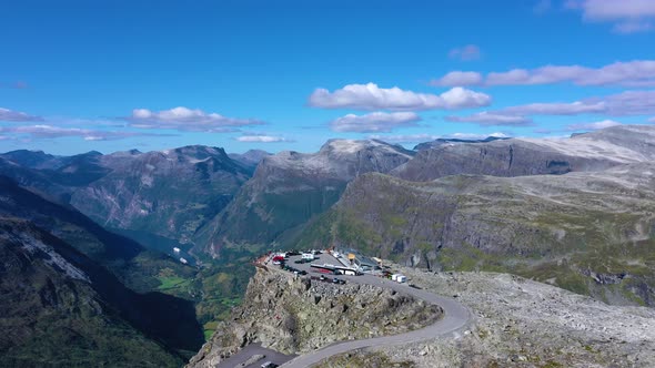 Flying over a Viewpoint with nice view of geiranger fjord and mountain peaks alt