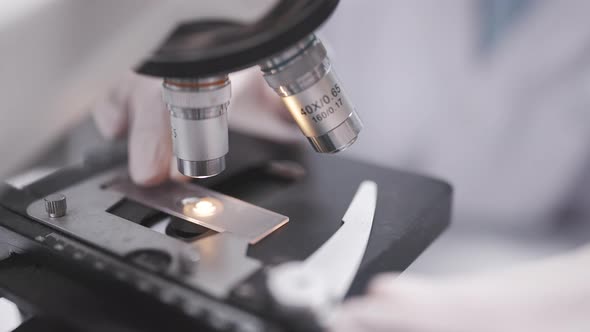 Researcher scientist using microscope to work in biotechnology laboratory medicine science biology