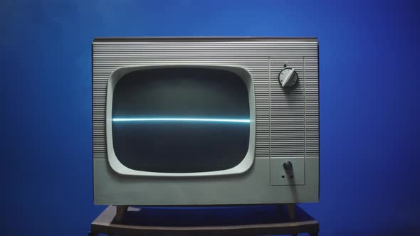 Old Retro Television on Blue Neon Background Closeup alt