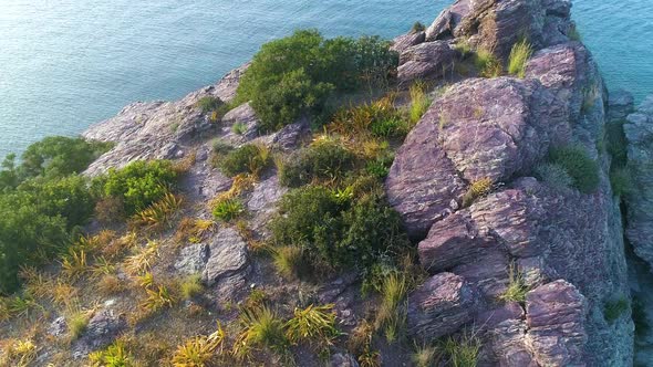 Aerial Top View of Cliff Rocks in a Blue Ocean alt
