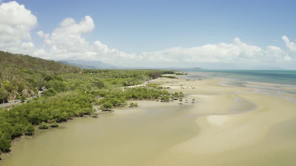 Aerial, Low Tide And Huge Sand Ocean Bed And Mangroves Growing In Queensland Australia