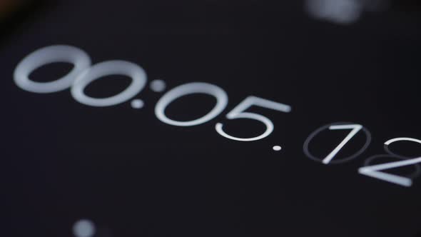 Numerical digital stopwatch with white number and black screen alt