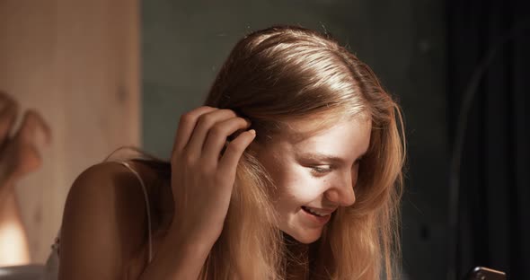 Caucasian woman using smartphone in hotel alt