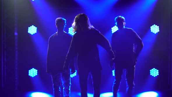 Silhouettes of a Talented Group Young Hip Hop Dancers. Hip Hop Street Dance on a Stage in Dark alt