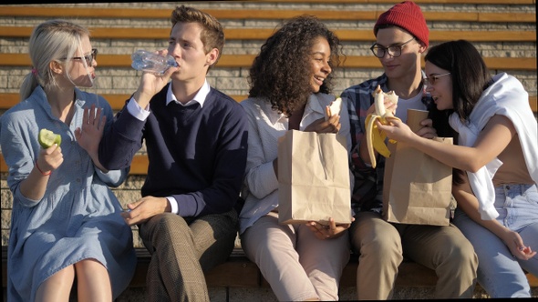 Happy friends, laughing, eating , joking, having fun. alt