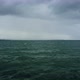 Drone Shot Low Over Ocean Surface Stormy Weather with a Downpour on the Horizon - VideoHive Item for Sale