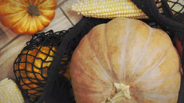 Lot of autumn pumpkins and seasonal autumn vegetables in shopping bag. alt
