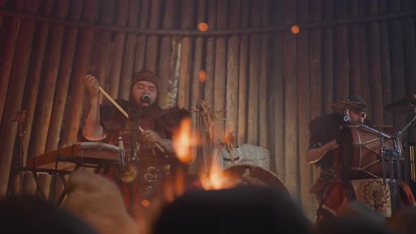 Plump Man Sings While Friend Plays Drums in Altai House alt