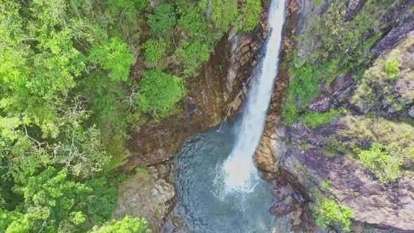 Flycam Rises High Above Waterfall TaGu Against Landscape alt