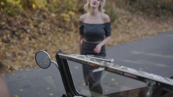 Passionate Lady Comes to Cabriolet and Poses with Smile at Camera alt