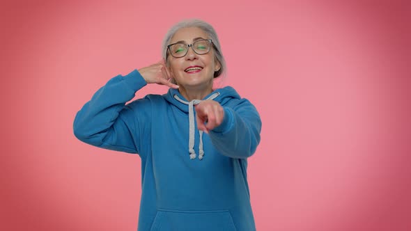 Elderly Granny Grayhaired Woman Looking at Camera Doing Phone Gesture Like Say Hey you Call Me Back alt