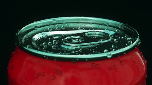 Red Aluminum Can with a Drink on a Black Background Closeup