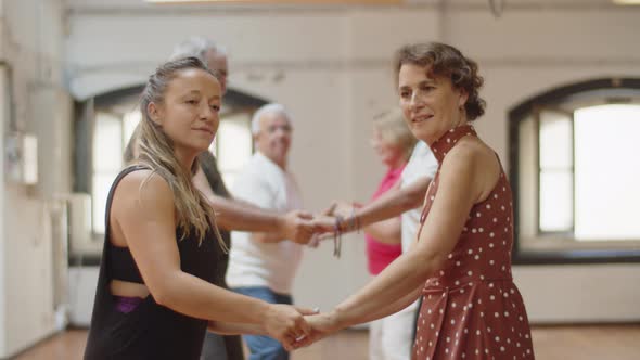 Side View of Couples Taking Dance Class in Ballroom alt