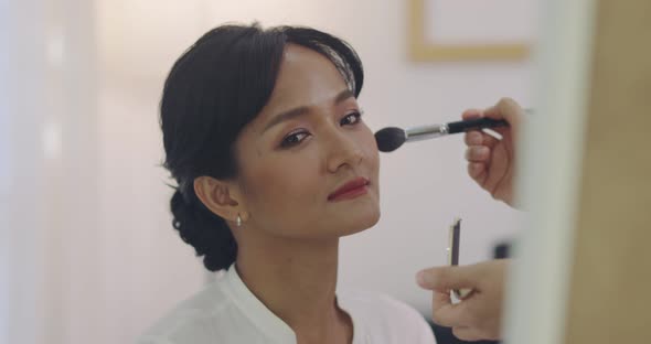 Asian Wedding Makeup Artist Making A Make Up For Bride. Artist Applying Cosmetic On Bride Face. alt