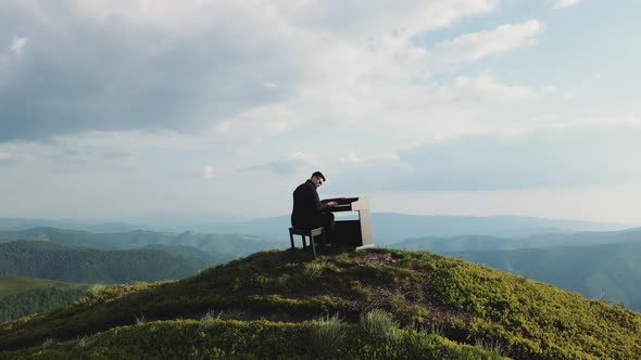 Man Two Hands Plays Gentle Classical Music on a Grand Piano on Nature