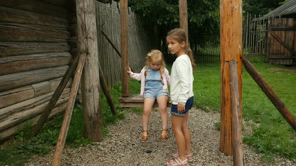 Kids Walk At Authentic Village, Children On Wooden Swing Sets
