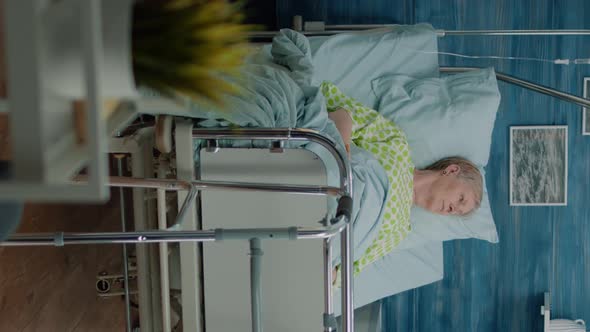 Vertical Video Retired Patient with Disease Sitting in Hospital Bed alt