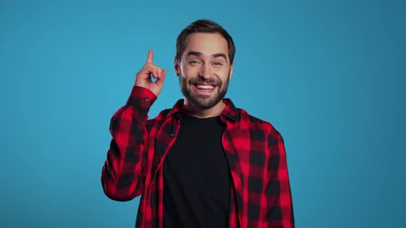 Portrait of Thinking Pondering Man Beard Having Idea Moment Pointing Finger Up alt