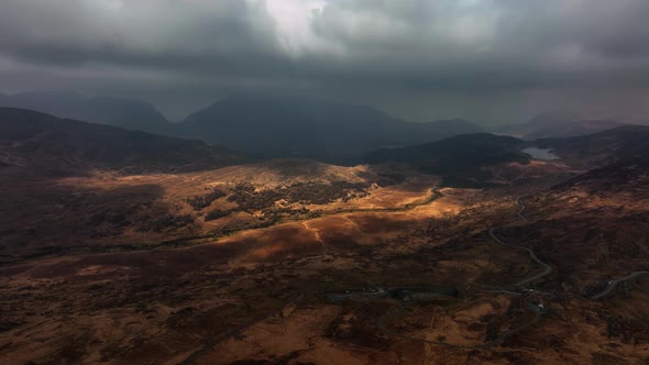 Killarney, Kerry, Ireland, March 2022. Drone tracks northwest over Derrynafunsha under a moody sky w alt
