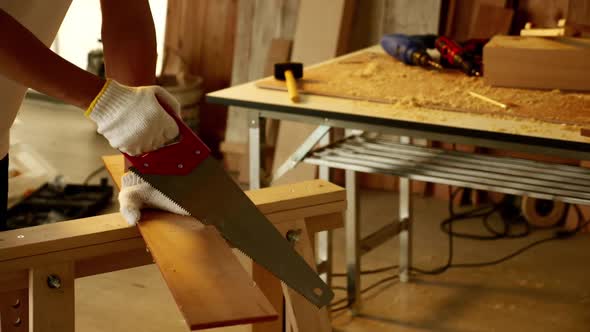 Woodwork and furniture making concept. Stylish craftsman working in his carpentry workshop alt