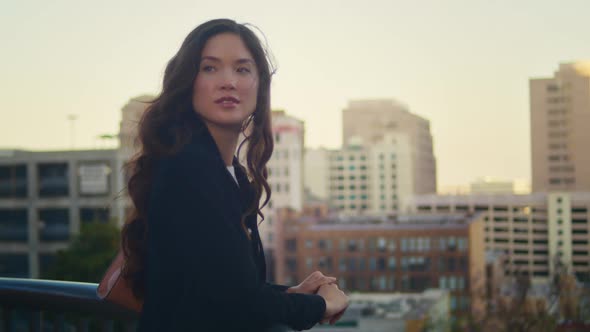 Portrait of Asian Woman Enjoy City View Near Railings alt
