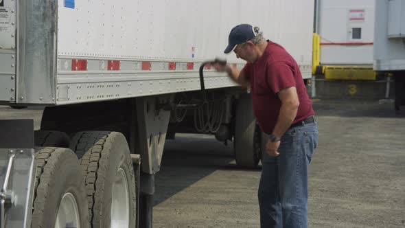 Truck driver preparing trailer.  Fully released for commercial use.