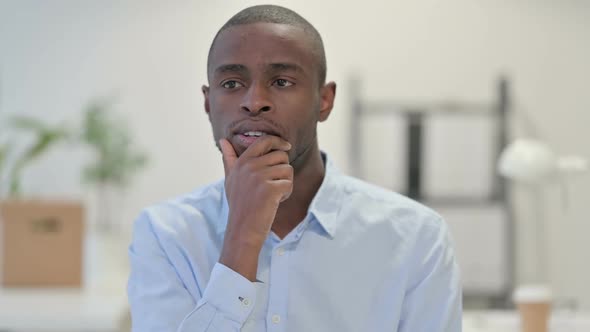 Portrait of Pensive African Man Thinking in Office alt