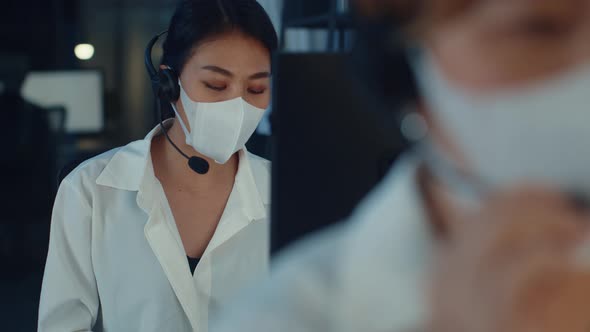 Asia young call center team or customer support service executive wearing face mask prevent.