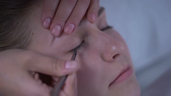 Master of Eyelash Extensions Adding Volume to Womans Lashes, Beauty Salon alt