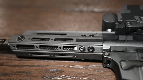 left to right slide over a AR style 9mm personal protection weapon with holographic sight optic alt