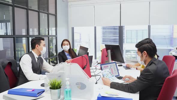 Group of Asian team business people wear face mask, working and meeting in office with new normal. alt