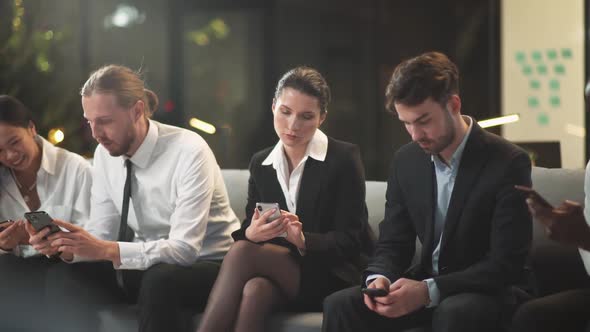 Group of People Sitting in the Waiting Room and Use Smartphones the Office Team Is Waiting for the alt