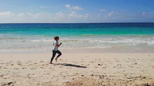 Sports Jogging on Vacation Along Coastline of Sea