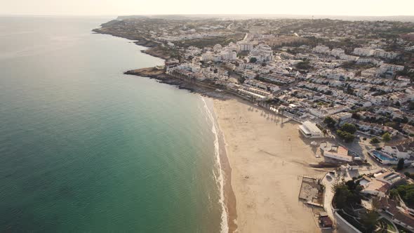 Warm sunny Algarve Beach Praia da Luz shoreline - Aerial fly-over alt