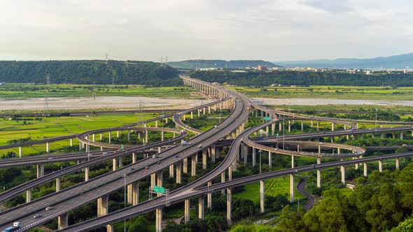 Time lapse of aerial view of cars driving on highway or freeway with trees in Taiwan.