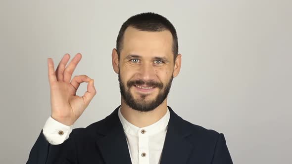 Young Handsome Businessman Says Ok and Shows Gesture Ok alt