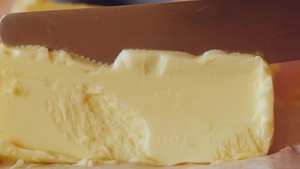 Knife Cutting of a Piece of Butter