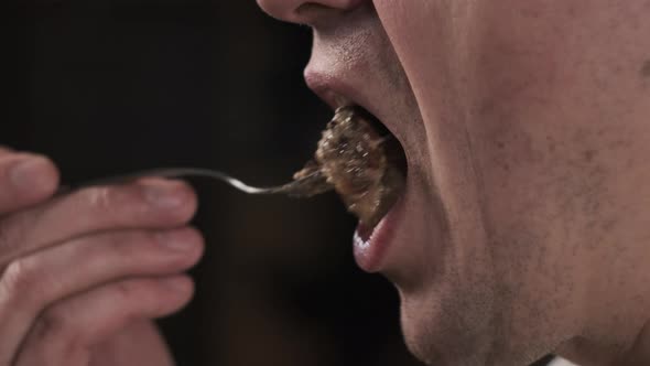 Close Up View of Person Eating Food From Fork alt