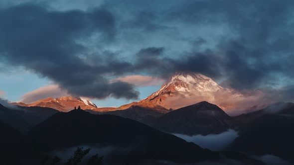 Time lapse of clouds hiding Mt Kazbek at sunrise in Caucacus mountains, Georgia alt
