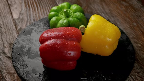 Red Yellow Orange Bell Peppers on a Wooden Cutting Board alt