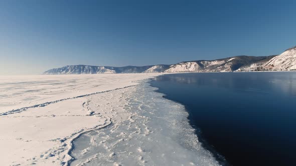 Ice on River Lake. A Frozen Field Snow and Ice. Russia Siberia Baikal Freshwater Freezing