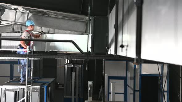 Air Ventilation Technician with Flashlight Looking For Potential Issues with the System alt