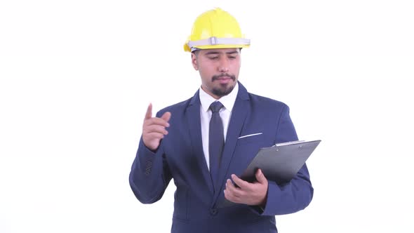 Happy Bearded Persian Businessman As Engineer Talking While Holding Clipboard alt