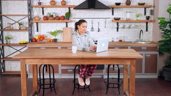 Female in Cozy Clothes Using Computer at Home