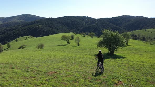 Aerial View Of The Cyclist Ride A Bike In The Green Mountains 4 alt