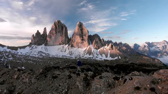 Aerial Man Hiker Walking In Front of Tre Cime di Lavaredo Mountain in Dolomites Italy