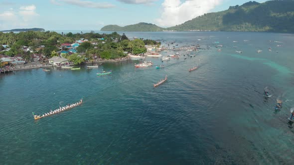 Aerial: kora-kora traditional canoe annual race in Bandaneira and speed boats alt